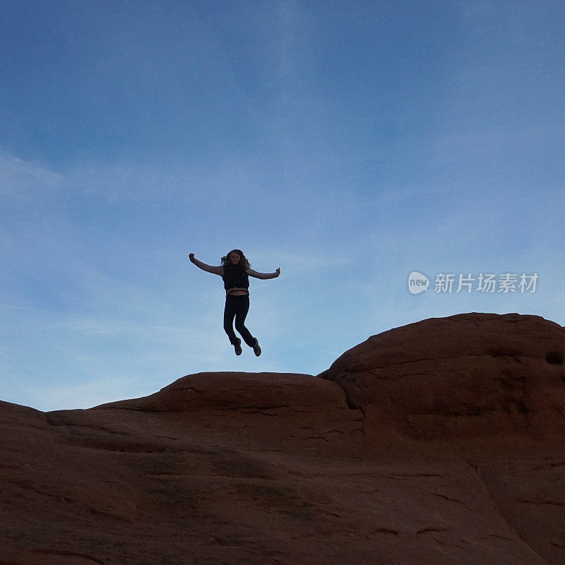 Jumping Mid-air Person Silhouette, Curved Rock Formation